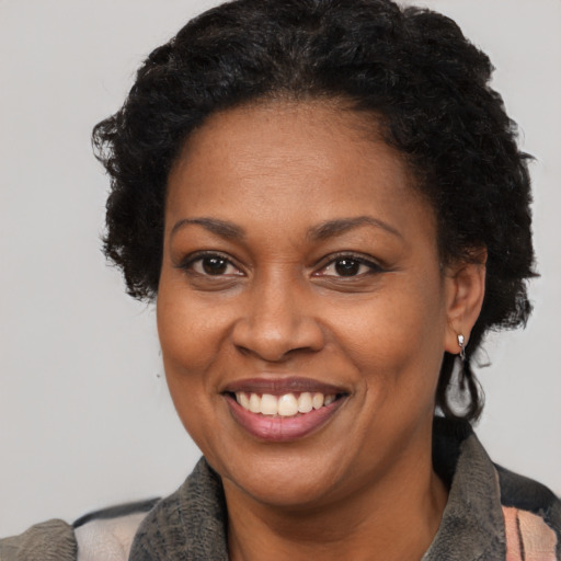 Joyful black adult female with short  brown hair and brown eyes