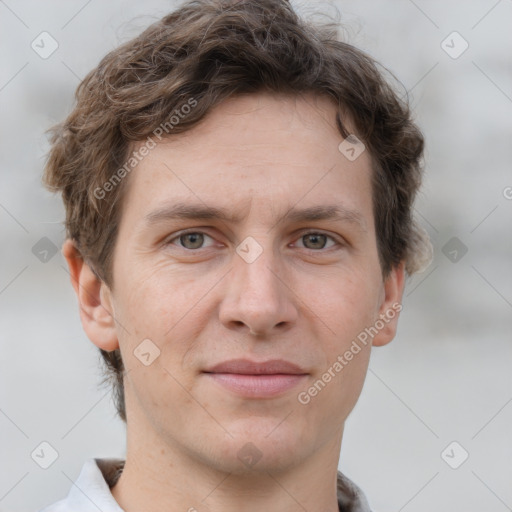 Joyful white adult male with short  brown hair and grey eyes