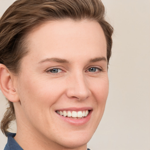 Joyful white young-adult female with medium  brown hair and blue eyes