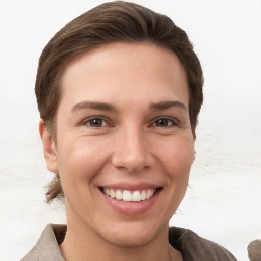 Joyful white young-adult female with short  brown hair and grey eyes