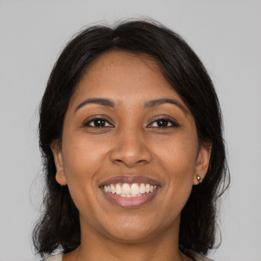 Joyful black young-adult female with medium  black hair and brown eyes
