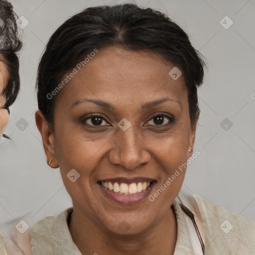 Joyful latino adult female with medium  brown hair and brown eyes