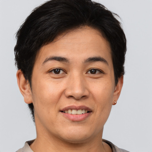 Joyful asian adult female with short  brown hair and brown eyes