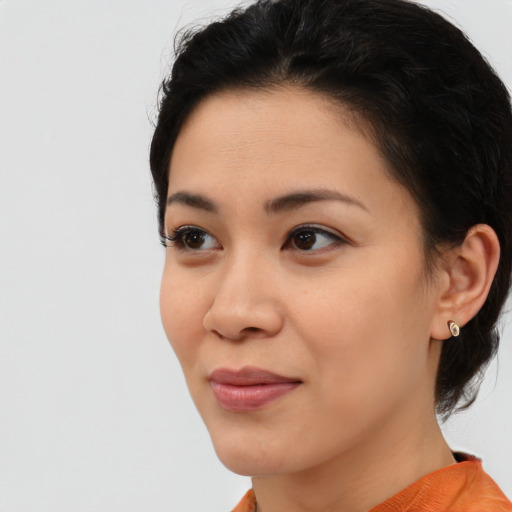Joyful latino young-adult female with medium  black hair and brown eyes