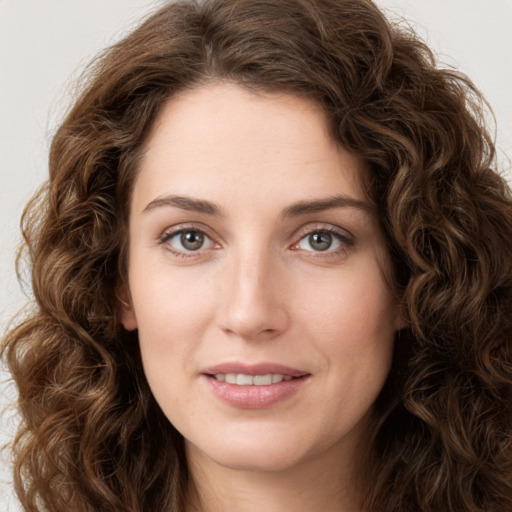 Joyful white young-adult female with long  brown hair and green eyes