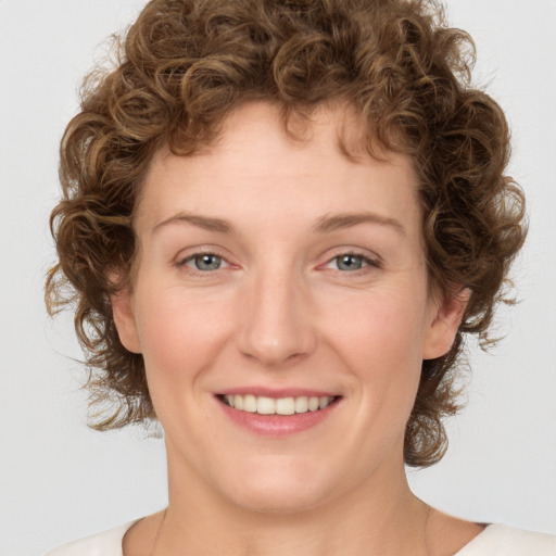 Joyful white young-adult female with medium  brown hair and green eyes