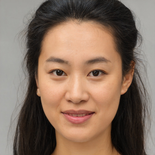 Joyful asian young-adult female with medium  brown hair and brown eyes