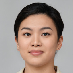 Joyful asian young-adult female with medium  brown hair and brown eyes