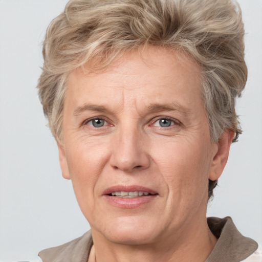 Joyful white middle-aged female with short  brown hair and grey eyes