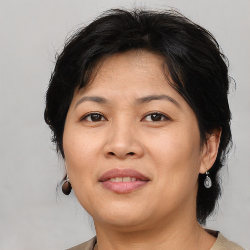 Joyful asian adult female with medium  brown hair and brown eyes