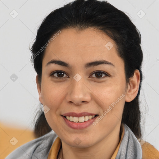 Joyful asian young-adult female with medium  brown hair and brown eyes