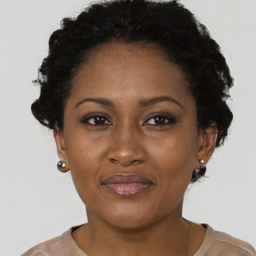 Joyful black adult female with short  brown hair and brown eyes