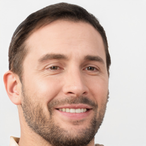 Joyful white young-adult male with short  brown hair and brown eyes