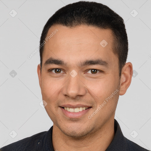 Joyful white young-adult male with short  black hair and brown eyes