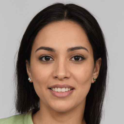 Joyful latino young-adult female with long  brown hair and brown eyes