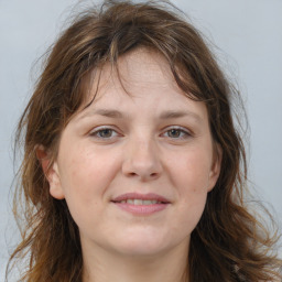 Joyful white adult female with long  brown hair and brown eyes