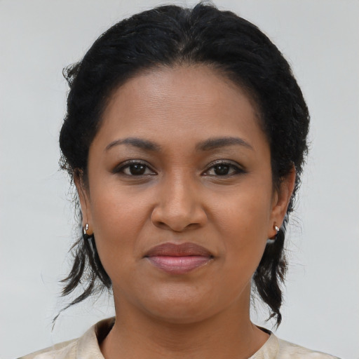 Joyful black young-adult female with medium  brown hair and brown eyes