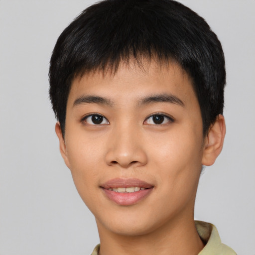 Joyful asian young-adult male with short  black hair and brown eyes