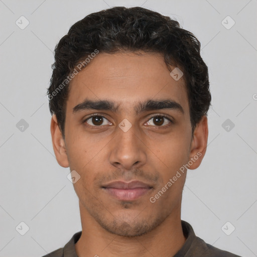 Joyful latino young-adult male with short  brown hair and brown eyes