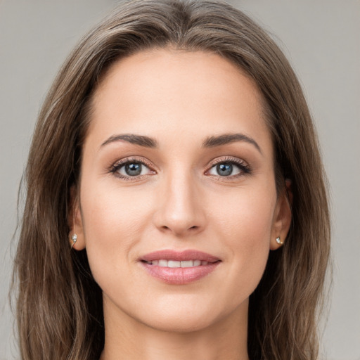 Joyful white young-adult female with long  brown hair and grey eyes