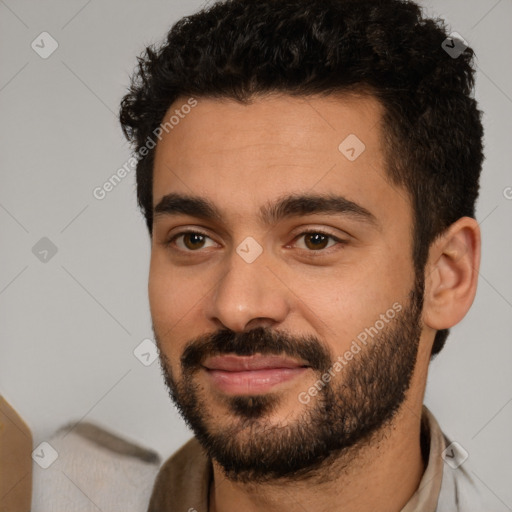 Joyful white young-adult male with short  black hair and brown eyes