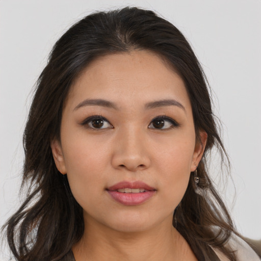 Joyful white young-adult female with long  brown hair and brown eyes