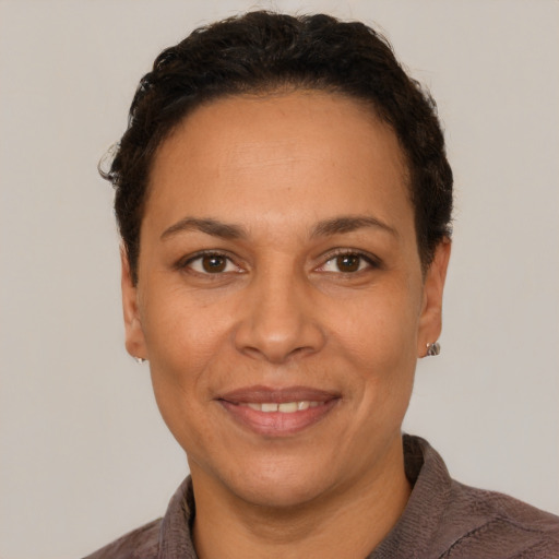 Joyful white adult female with short  brown hair and brown eyes