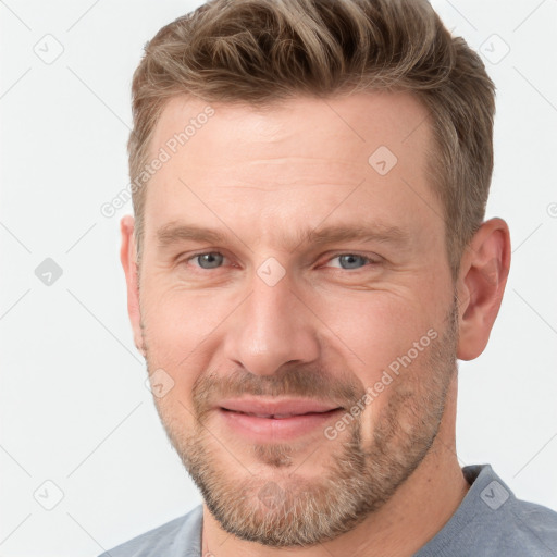 Joyful white adult male with short  brown hair and grey eyes