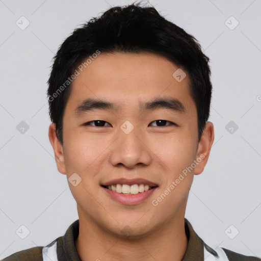 Joyful asian young-adult male with short  black hair and brown eyes