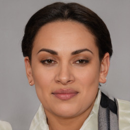 Joyful latino young-adult female with medium  brown hair and brown eyes