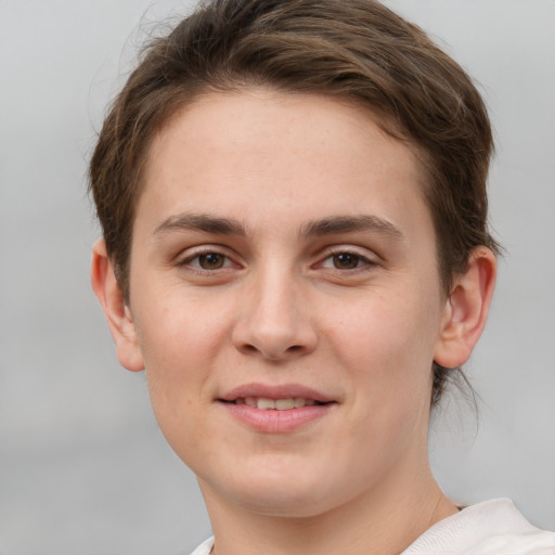 Joyful white young-adult female with short  brown hair and grey eyes