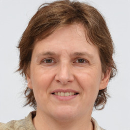 Joyful white adult female with medium  brown hair and grey eyes