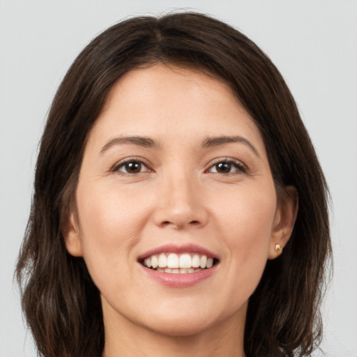 Joyful white young-adult female with medium  brown hair and brown eyes