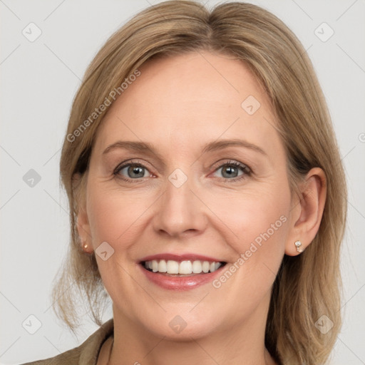 Joyful white adult female with medium  brown hair and grey eyes