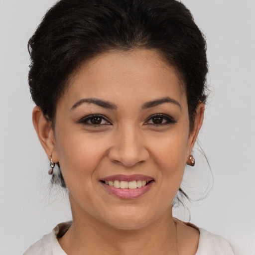 Joyful latino young-adult female with short  brown hair and brown eyes