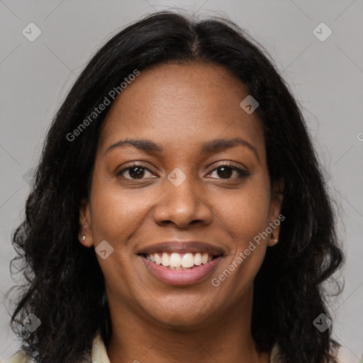 Joyful black young-adult female with long  brown hair and brown eyes