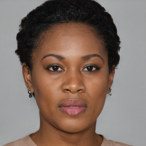 Joyful black young-adult female with short  black hair and brown eyes