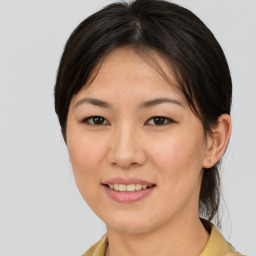 Joyful asian young-adult female with medium  brown hair and brown eyes