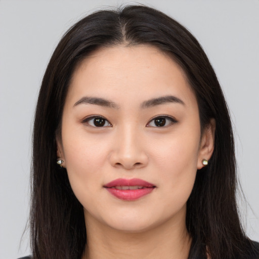 Joyful asian young-adult female with long  brown hair and brown eyes