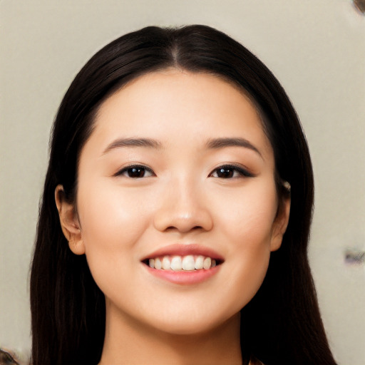 Joyful asian young-adult female with long  black hair and brown eyes