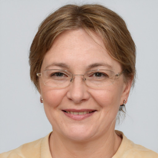 Joyful white adult female with medium  brown hair and brown eyes