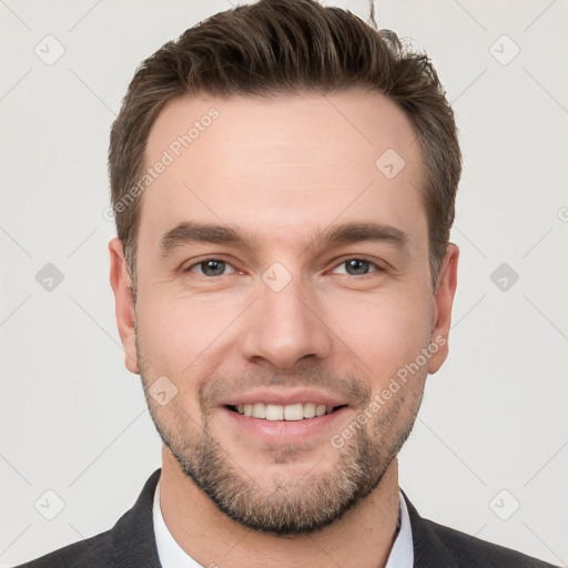 Joyful white young-adult male with short  brown hair and grey eyes