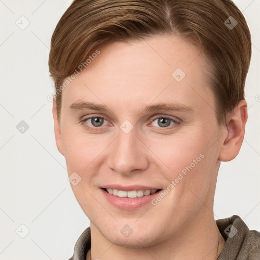 Joyful white young-adult female with short  brown hair and grey eyes