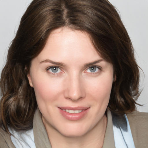 Joyful white young-adult female with medium  brown hair and blue eyes