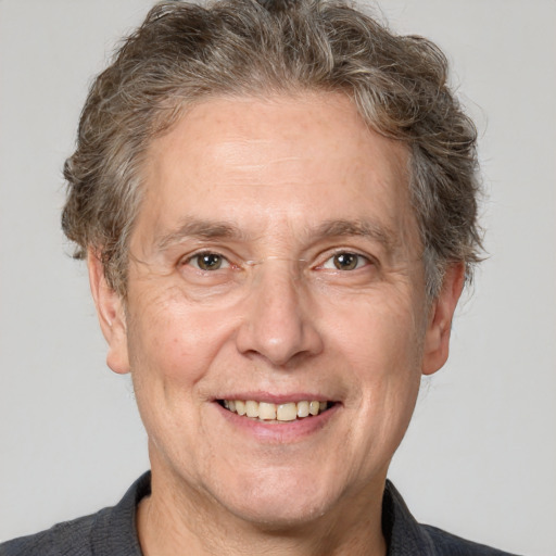 Joyful white middle-aged male with short  brown hair and grey eyes