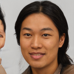 Joyful asian adult female with medium  brown hair and brown eyes