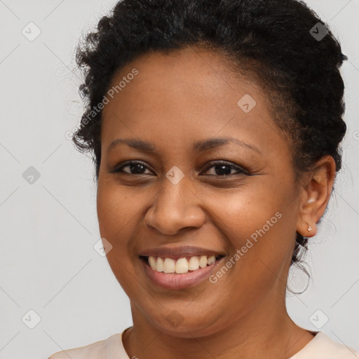 Joyful black young-adult female with short  brown hair and brown eyes