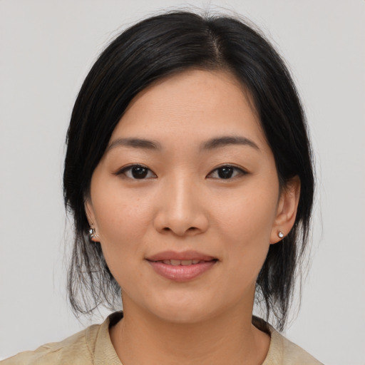 Joyful asian young-adult female with medium  black hair and brown eyes