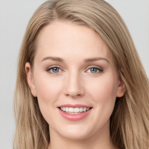 Joyful white young-adult female with long  brown hair and grey eyes