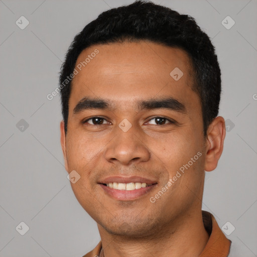 Joyful latino young-adult male with short  black hair and brown eyes